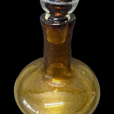 Sale Photo Thumbnail #142: This mid-century hand-blown art glass ship’s decanter is believed to be made by Blenko, or other art glass company of the era. Often referred to as a “Captain’s Decanter,” this piece has a wide, low-gravity base for stability. It is amber in color