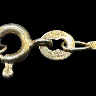 Sale Photo Thumbnail #149: This is a 14K yellow gold scroll chain bracelet. It has distinctive links that are created by two wires spiraling into each other. The length is 7” long. It is stamped “14K, Italy.” The weight is 1.06 grams. [AG]