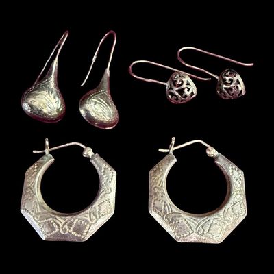 Sale Photo Thumbnail #163: This sterling silver earrings assortment includes a pair of hoop earrings, and two pairs of drop earrings. Total of three pairs of earrings. The total weight is 9.71 grams. The silver content of some pieces may have been confirmed with testing. [AG]