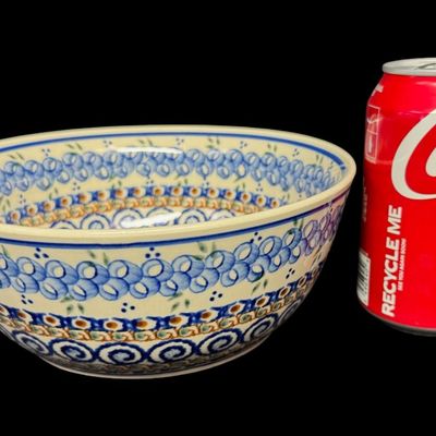 Sale Photo Thumbnail #188: The design on this piece showcases a repeating “blue rings” or abstract floral berry motif, framed by traditional geometric accents and a dark blue rim. This is an authentic Unikat piece from the highly prestigious Ceramika Artystyczna factory. Measur