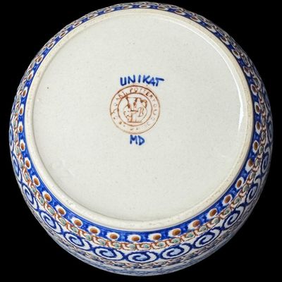 Sale Photo Thumbnail #189: The design on this piece showcases a repeating “blue rings” or abstract floral berry motif, framed by traditional geometric accents and a dark blue rim. This is an authentic Unikat piece from the highly prestigious Ceramika Artystyczna factory. Measur