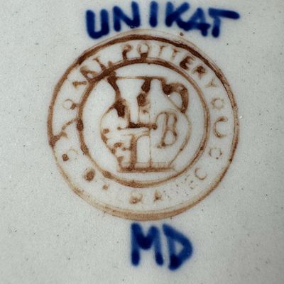 Sale Photo Thumbnail #190: The design on this piece showcases a repeating “blue rings” or abstract floral berry motif, framed by traditional geometric accents and a dark blue rim. This is an authentic Unikat piece from the highly prestigious Ceramika Artystyczna factory. Measur