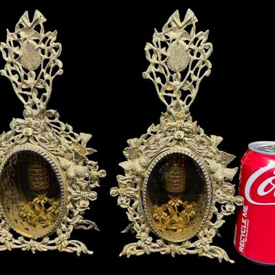 Sale Photo Thumbnail #199: Most likely from the mid-20th century, these structures feature heavily detailed gilt brass filigree with motifs of flowers, scrolling vines, and birds, surrounding the center. There are encased perfume bottles in each piece. Total of two pieces. One is m