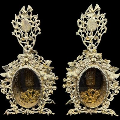 Sale Photo Thumbnail #198: Most likely from the mid-20th century, these structures feature heavily detailed gilt brass filigree with motifs of flowers, scrolling vines, and birds, surrounding the center. There are encased perfume bottles in each piece. Total of two pieces. One is m