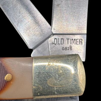 Sale Photo Thumbnail #221: Includes an Old Timer Model 12OT “PAL” single blade knife, an Old Timer Model 95OT “Gunstock Trapper” two blade knife, and a Schrade 890TY “Blazer” three blade knife. Total of three knives. The longest knife measures 4.25” long in the closed