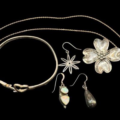 Sale Photo Thumbnail #232: This sterling silver assortment includes a bracelet, a brooch, a cable chain with a gold vermeil wash, and three single earrings. The chain length is 20 inches. The total weight is 22.28 grams. The silver content of some pieces was verified with testing. 