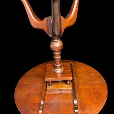 Sale Photo Thumbnail #301: This table is complete, and functions as it should. It is mahogany in color. There is a crack on the top of the pedestal base (pictured). Measurement: 28”H x 30” Diameter. [VB]