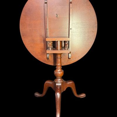 Sale Photo Thumbnail #302: This table is complete, and functions as it should. It is mahogany in color. There is a crack on the top of the pedestal base (pictured). Measurement: 28”H x 30” Diameter. [VB]