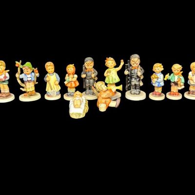Sale Photo Thumbnail #333: Includes a total of 17 Hummel figurines. All were made by Goebel of Germany. There may or may not be flea bites to some of the figurines. Measurement of tallest: 4.5”H. [AG]