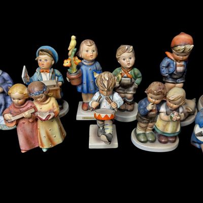 Sale Photo Thumbnail #339: Includes a total of 15 Hummel figurines. All were made by Goebel of Germany. There may or may not be flea bites on some pieces. Some pieces have been repaired. Measurement of tallest: 6”H. [AG]