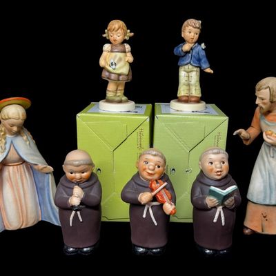 Sale Photo Thumbnail #346: Includes two NOS boxed Hummels, and five vintage religious Hummels. Total of seven pieces. All were made by Goebel of Germany. There may or may not be flea bites. Measurement of tallest: 7.5”H. [AG]