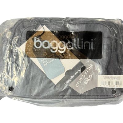 Sale Photo Thumbnail #410: Includes a black waterproof crossbody/shoulder bag, and a Baggalini triple zip bag. Total of two unopened bags. The crossbody bag has an anti-theft RFID chip. Measurement of largest: 14” x 9”. [GG]