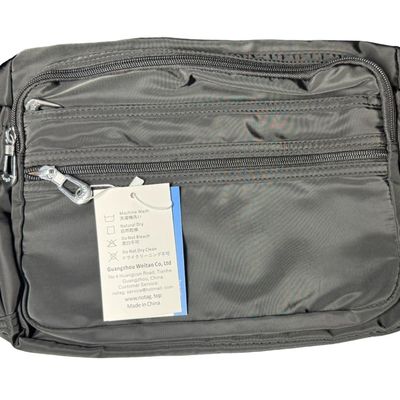 Sale Photo Thumbnail #411: Includes a black waterproof crossbody/shoulder bag, and a Baggalini triple zip bag. Total of two unopened bags. The crossbody bag has an anti-theft RFID chip. Measurement of largest: 14” x 9”. [GG]