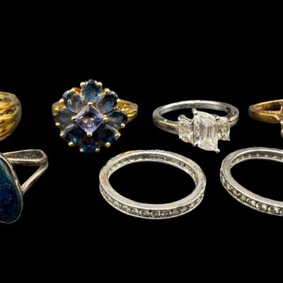 Sale Photo Thumbnail #423: Includes onyx, Long Blue topaz, CZ, and more. Some pieces have a gold vermeil wash. Total of seven rings. The total weight is 26.00 grams. [GG]