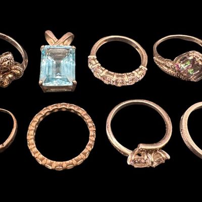 Sale Photo Thumbnail #428: Includes rings, a toe ring, and a blue topaz pendant. Stones include mystic topaz, CZ, turquoise, and more. Total of eight pieces. The total weight is 26.62 grams. [GG]