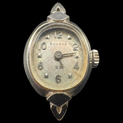 Sale Photo Thumbnail #429: This is a Bulova M7 manual wind ladies’ watch, in 14K white gold, made in 1967. It has 23 jewels. It has been personalized on the reverse. The watch was not tested, and may be over-wound. The original band is missing. The overall weight, including movem