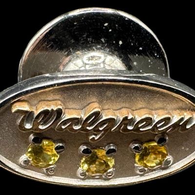 Sale Photo Thumbnail #434: Includes a 14K yellow gold stick pin with a garnet, a 10K yellow gold Shriners pin, and a 10K white gold “Walgreen” pin with three citrine stones. Weight of 14K: 1.33 grams. Weight of 10K: 2.07 grams. The pin backs were removed before weighing. The go