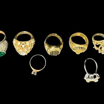 Sale Photo Thumbnail #479: Includes gold tone, silver tone, stones, faux pearls, and more. There are both men’s and ladies’ rings in various styles. Total of ten rings. [PM]