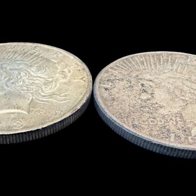 Sale Photo Thumbnail #506: Includes a 1923 Peace dollar, and a 1923-S Peace dollar. Total of two ungraded coins. The silver content is 90%. [PM]