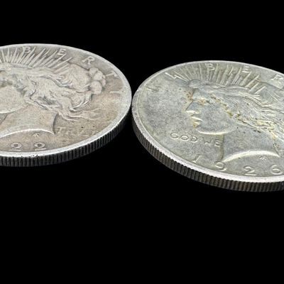 Sale Photo Thumbnail #510: Includes a 1922-S Peace dollar, and a 1926 Peace dollar. Total of two ungraded coins. The silver content is 90%. [PM]