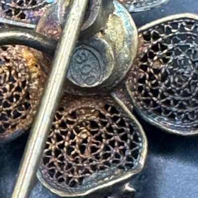Sale Photo Thumbnail #530: This .800 silver pin/brooch features filigree throughout, with gold vermeil accents adding depth to this lovely piece. The weight is 3.82 grams. [GG]