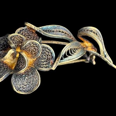 Sale Photo Thumbnail #528: This .800 silver pin/brooch features filigree throughout, with gold vermeil accents adding depth to this lovely piece. The weight is 3.82 grams. [GG]