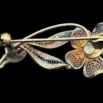 Sale Photo Thumbnail #529: This .800 silver pin/brooch features filigree throughout, with gold vermeil accents adding depth to this lovely piece. The weight is 3.82 grams. [GG]