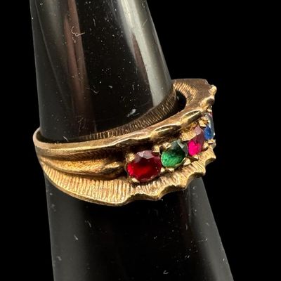 Sale Photo Thumbnail #532: This multi-stone ring features emerald, ruby, and sapphire stones prong-set in a satin finish background. The ring may be slightly out of round. The ring size is 5.75. The weight is 3.02 grams. [GG]