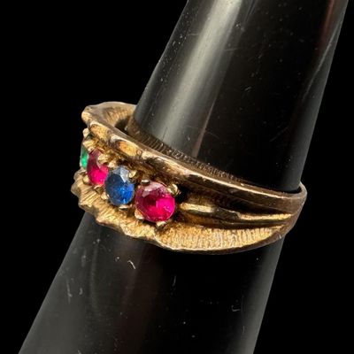 Sale Photo Thumbnail #533: This multi-stone ring features emerald, ruby, and sapphire stones prong-set in a satin finish background. The ring may be slightly out of round. The ring size is 5.75. The weight is 3.02 grams. [GG]