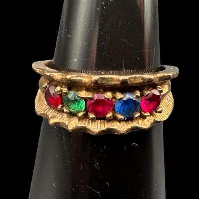 Sale Photo Thumbnail #531: This multi-stone ring features emerald, ruby, and sapphire stones prong-set in a satin finish background. The ring may be slightly out of round. The ring size is 5.75. The weight is 3.02 grams. [GG]