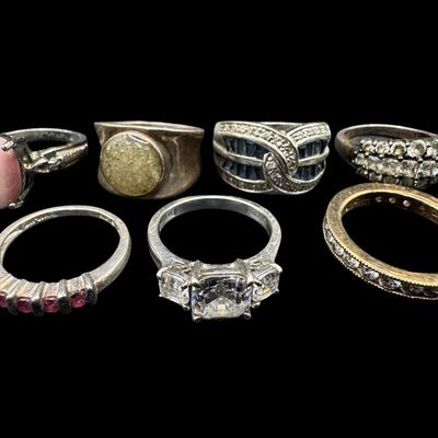 Sale Photo Thumbnail #539: Includes moonstone, tiger’s eye, CZ, and more. Total of seven rings. The total weight is 36.77 grams. [GG]