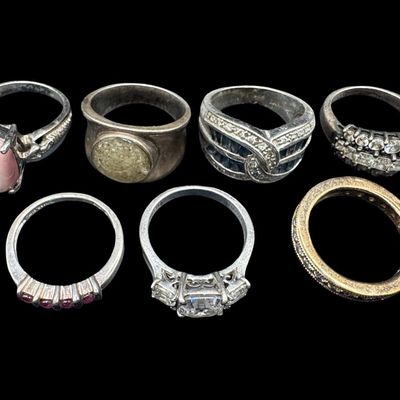 Sale Photo Thumbnail #540: Includes moonstone, tiger’s eye, CZ, and more. Total of seven rings. The total weight is 36.77 grams. [GG]