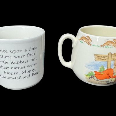Sale Photo Thumbnail #574: Includes a vintage Wedgwood Peter Rabbit mug from Beatrix Potter’s famous illustrations, and a Royal Doulton Bunnykins mug in the Albion shape. There is minimal crazing to the Wedgwood piece. There are no obvious chips or cracks in either piece. Measure