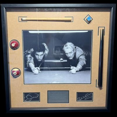 Sale Photo Thumbnail #633: This piece features an enlarged photo of Tom Cruise and Paul Newman, along with a pool stick, chalk, and cue balls. There is a marquis plaque commemorating this movie centered on the base. Measurement: 30” x 30”. [VB]