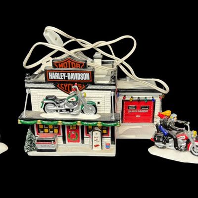 Sale Photo Thumbnail #637: From the original Snow Village Series. This retired set features a hand painted ceramic building along with detailed accessory pieces. Total of four pieces. This may or may not be complete. The separate HD sign with motorcycle on top has been repainted (p