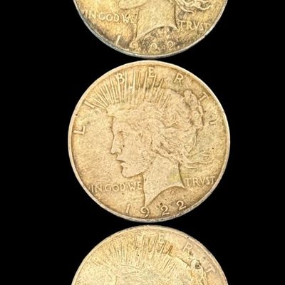 Sale Photo Thumbnail #675: Includes a 1922 Peace dollar, a 1922-D Peace dollar, and a 1922-S Peace dollar. Total of three ungraded coins. The silver content is 90%. [PM]
