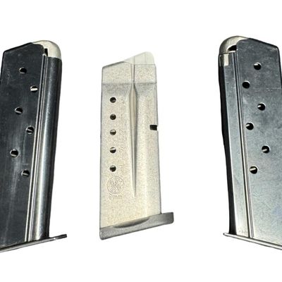 Sale Photo Thumbnail #704: Includes a Smith & Wesson seven-round 9mm magazine, and a pair of unbranded .45 caliber magazines. Total of three pieces. All are gently used. [GG]