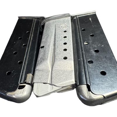 Sale Photo Thumbnail #706: Includes a Smith & Wesson seven-round 9mm magazine, and a pair of unbranded .45 caliber magazines. Total of three pieces. All are gently used. [GG]