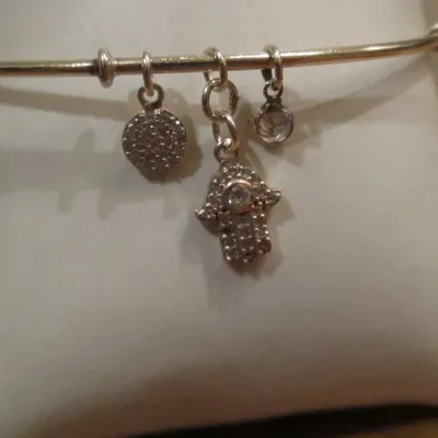 Sale Photo Thumbnail #324: Sterling silver signed 925 bangle bracelet with dangling Hamsa crystal hand and round crystal charms dangling braceletBracelet and charms are in good condition...toned and cleaned for immediate wearing.