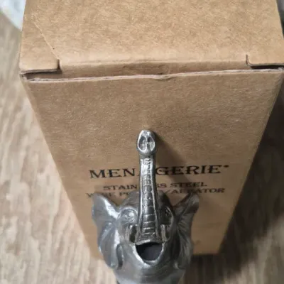 Sale Photo Thumbnail #137: The Elephant Head Pourer/Aerator/Stopper is a unique and fun addition to any bar collection. Made of metal with a silver color, this head-shaped pourer features an elephant design that adds a charming touch to your kitchen or home decor. Perfect for aerat