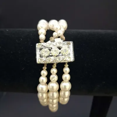 Sale Photo Thumbnail #143: Assorted costume jewelry lot featuring white bead and faux pearl stretch bracelets, a patriotic red, white and blue beaded bracelet, gold-tone fashion bracelets with faux pearls and rhinestones, a black-and-white bangle, and a coordinating white beaded ne