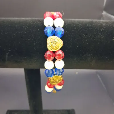 Sale Photo Thumbnail #147: Assorted costume jewelry lot featuring white bead and faux pearl stretch bracelets, a patriotic red, white and blue beaded bracelet, gold-tone fashion bracelets with faux pearls and rhinestones, a black-and-white bangle, and a coordinating white beaded ne