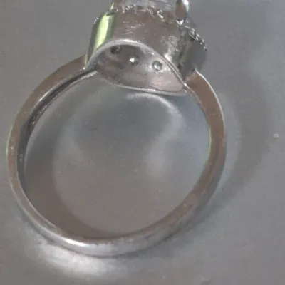 Sale Photo Thumbnail #176: Sterling Engagement Ring w/ CZ white zircon [ size 8.25 ]
Marked CFJ , located in Saginaw , Tx 1983.
Ring has a center CZ White Zircon in a halo setting
excel. condition,  no scuffs to naked eye