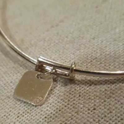 Sale Photo Thumbnail #346: Sterling silver signed 925 bangle bracelet with dangling Hamsa crystal hand and round crystal charms dangling braceletBracelet and charms are in good condition...toned and cleaned for immediate wearing.
