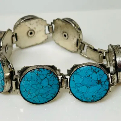 Sale Photo Thumbnail #10: Bold Southwestern style meets vivid blue matrix stones in this substantial link bracelet, featuring large round turquoise-look cabochons set in a silver-tone articulated design that makes a striking statement whether worn alone or layered with other favor
