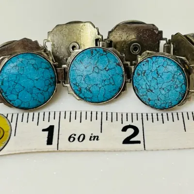 Sale Photo Thumbnail #12: Bold Southwestern style meets vivid blue matrix stones in this substantial link bracelet, featuring large round turquoise-look cabochons set in a silver-tone articulated design that makes a striking statement whether worn alone or layered with other favor