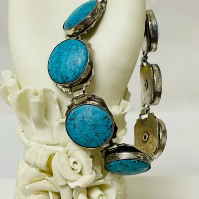 Sale Photo Thumbnail #9: Bold Southwestern style meets vivid blue matrix stones in this substantial link bracelet, featuring large round turquoise-look cabochons set in a silver-tone articulated design that makes a striking statement whether worn alone or layered with other favor