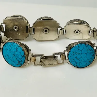 Sale Photo Thumbnail #11: Bold Southwestern style meets vivid blue matrix stones in this substantial link bracelet, featuring large round turquoise-look cabochons set in a silver-tone articulated design that makes a striking statement whether worn alone or layered with other favor
