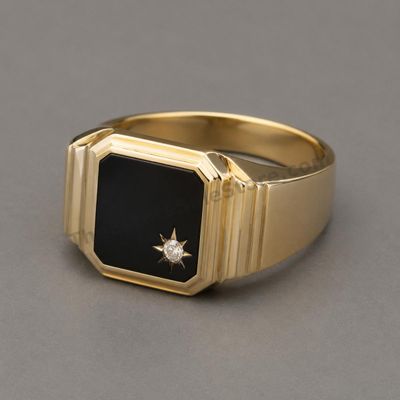 Sale Photo Thumbnail #4: Substantial men's yellow-gold signet ring set with a rectangular black onyx-style panel and a small round diamond-style accent. Stepped shoulders give the ring a classic mid-century appearance. Marked 10K; approximate ring size 10 and estimated gross weig