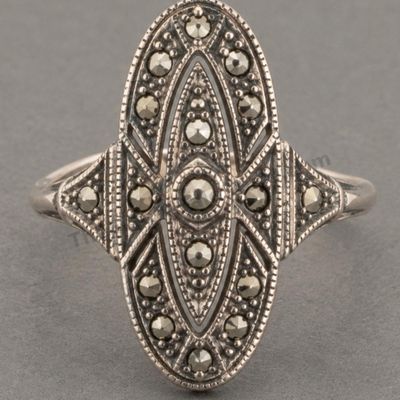 Sale Photo Thumbnail #5: Art Deco-inspired sterling silver ring with an elongated oval openwork face set with numerous marcasite-style accents. Decorative milgrain edging and geometric details continue onto the shoulders. Marked 925; approximate ring size 6.5 and estimated gross 